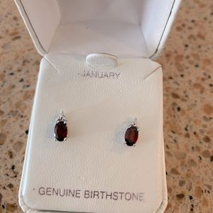 Sterling silver garnet stud earrings with diamond accents